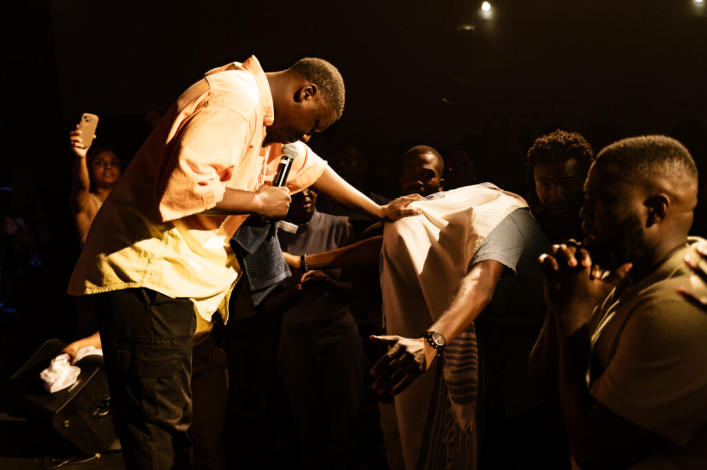 WYPP leaders praying with young adults at a gathering